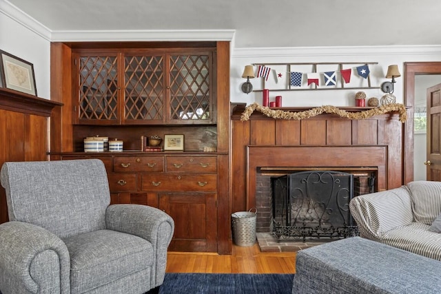 416 River Rd, Edgecomb, ME 04556 - living area with a fireplace, light wood-type flooring, and ornamental molding