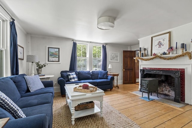 416 River Rd, Edgecomb, ME 04556 - living area with light wood-type flooring, ornamental molding, and a baseboard radiator