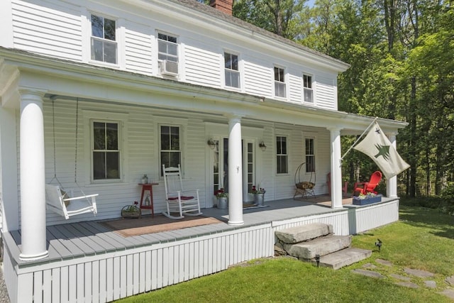 416 River Rd, Edgecomb, ME 04556 - view of front of property with covered porch, a chimney, and a front lawn