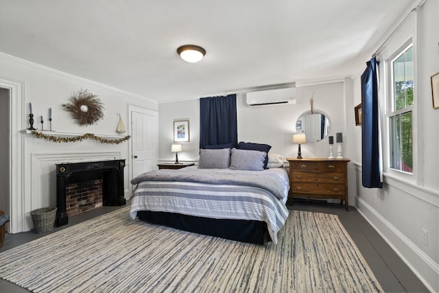 416 River Rd, Edgecomb, ME 04556 - bedroom featuring an AC wall unit, a fireplace, and ornamental molding