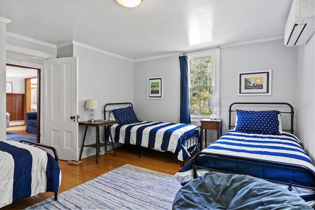 416 River Rd, Edgecomb, ME 04556 - bedroom with a wall unit AC, wood finished floors, ornamental molding, and a baseboard heating unit