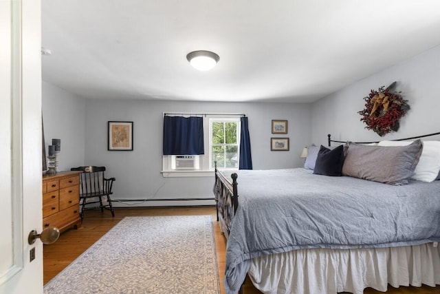 416 River Rd, Edgecomb, ME 04556 - bedroom with wood finished floors and a baseboard heating unit