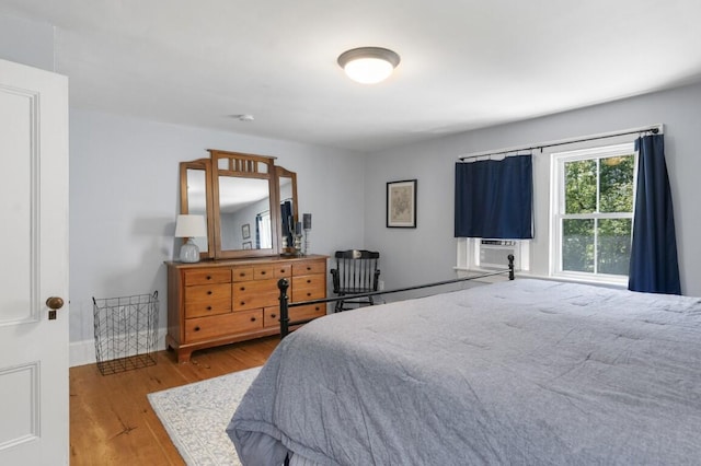 416 River Rd, Edgecomb, ME 04556 - bedroom with wood finished floors and cooling unit