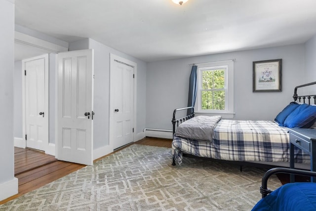 416 River Rd, Edgecomb, ME 04556 - bedroom featuring wood finished floors and a baseboard heating unit