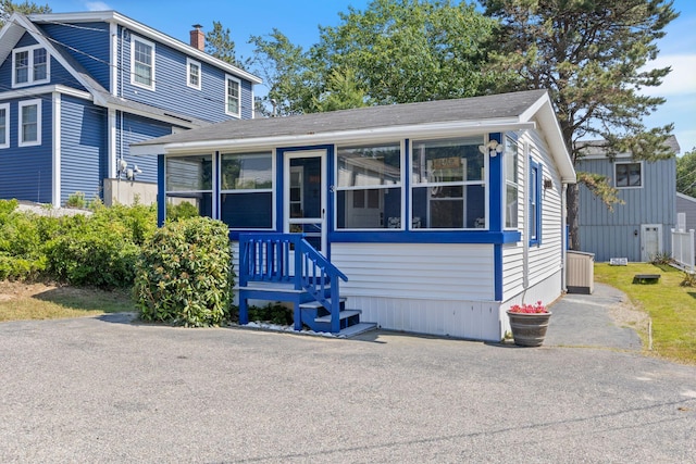 3 Island View Ave, Saco, ME 04072 - view of front facade featuring a sunroom, roof with shingles, and a chimney
