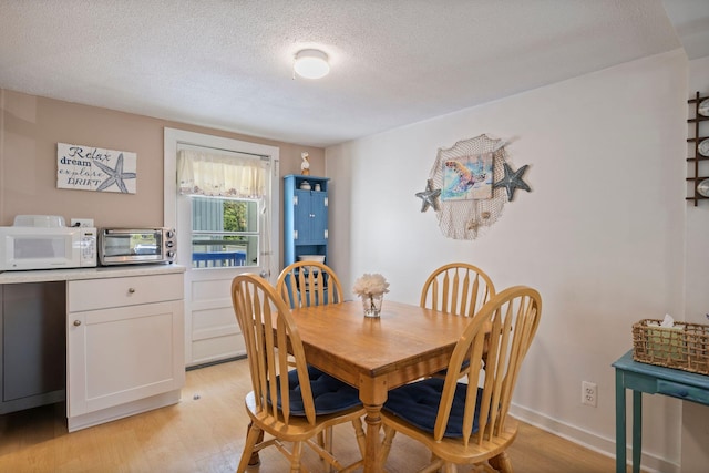 3 Island View Ave, Saco, ME 04072 - dining room featuring a textured ceiling and light wood-style flooring