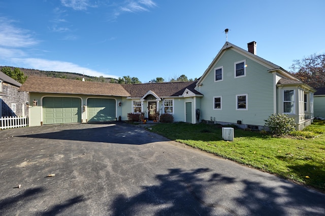 259 Mountain St, Camden, ME 04843 - view of front of home with an attached garage, asphalt driveway, a front lawn, and a chimney