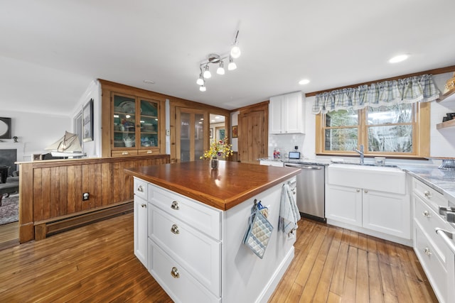 259 Mountain St, Camden, ME 04843 - kitchen featuring dishwasher, light wood-type flooring, a kitchen island, and white cabinets