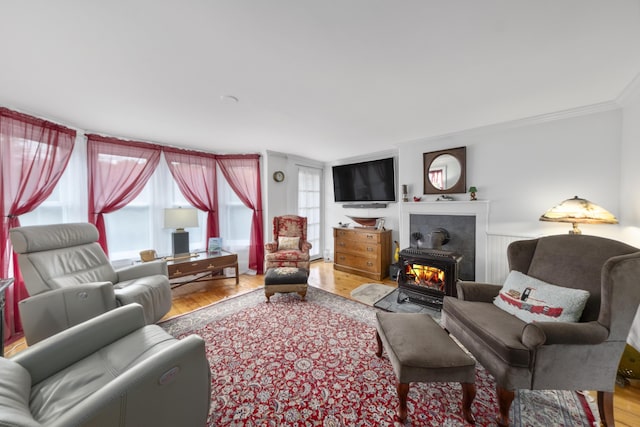 259 Mountain St, Camden, ME 04843 - living area with wood finished floors, ornamental molding, and a wood stove
