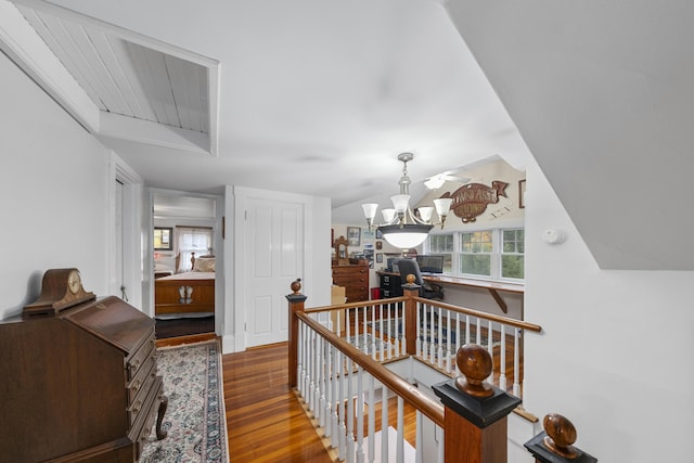 259 Mountain St, Camden, ME 04843 - corridor featuring wood finished floors, an upstairs landing, and a chandelier