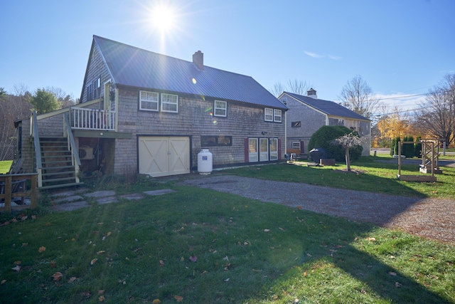 259 Mountain St, Camden, ME 04843 - rear view of house with stairs, an attached garage, a yard, a chimney, and a metal roof