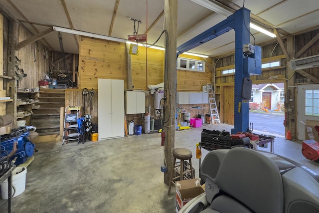 259 Mountain St, Camden, ME 04843 - garage featuring wooden walls, a garage door opener, and a workshop area