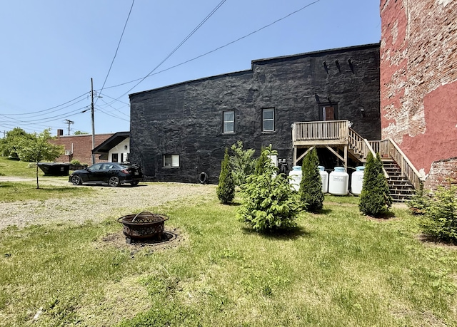 339 Main St, Calais, ME 04619 - view of home's exterior featuring a fire pit, stairway, and a yard