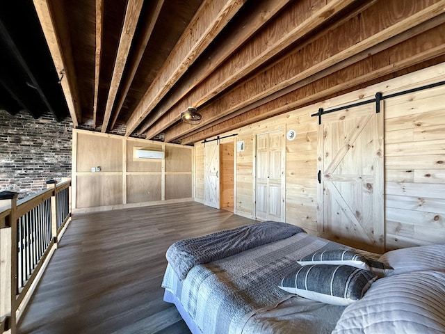 339 Main St, Calais, ME 04619 - bedroom featuring a barn door, wood finished floors, and wooden walls
