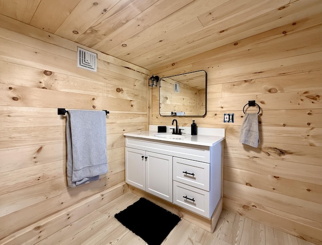 339 Main St, Calais, ME 04619 - bathroom featuring wooden walls, vanity, wooden ceiling, and wood-type flooring