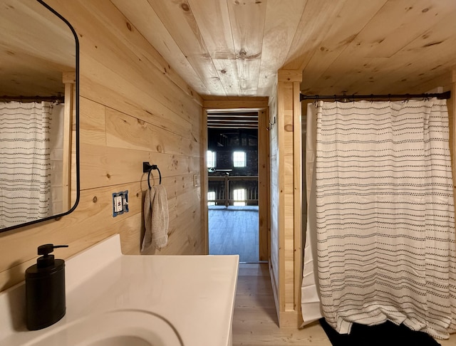 339 Main St, Calais, ME 04619 - bathroom with wood ceiling, wood walls, wood finished floors, vanity, and curtained shower