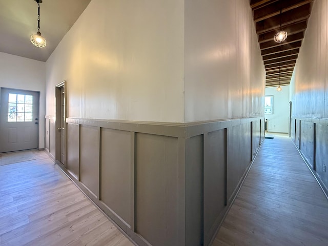 339 Main St, Calais, ME 04619 - corridor with a decorative wall, light wood finished floors, wainscoting, and high vaulted ceiling