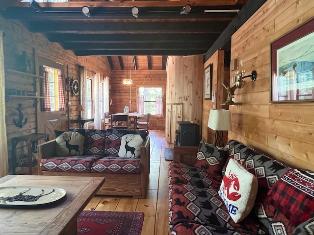 33 Mountain View Rd, Boothbay Harbor, ME 04538 - living room with wood walls, hardwood / wood-style flooring, beam ceiling, and a wood stove