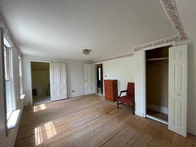 1069 Rte 193, Deblois, ME 04622 - unfurnished bedroom with light wood-type flooring, connected bathroom, and a closet