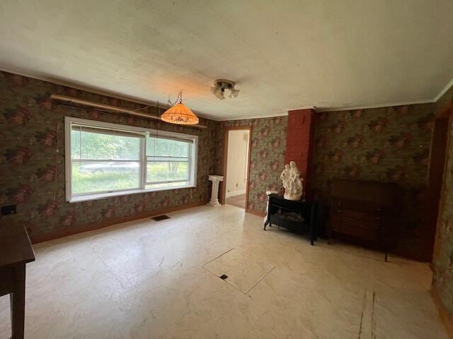 1069 Rte 193, Deblois, ME 04622 - unfurnished living room featuring a wood stove and tile patterned floors