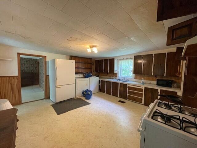 1069 Rte 193, Deblois, ME 04622 - kitchen with white appliances, a wainscoted wall, light countertops, washer and dryer, and dark brown cabinets