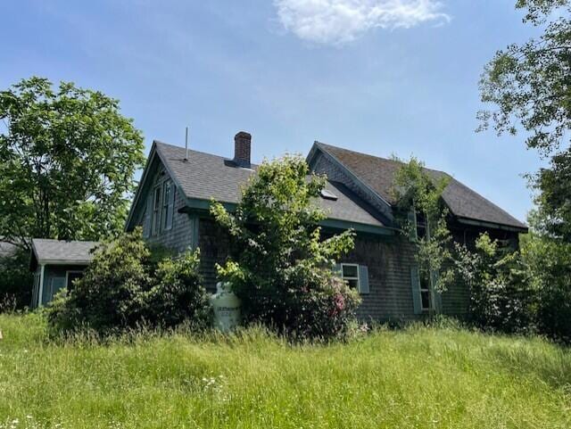1069 Rte 193, Deblois, ME 04622 - view of side of property featuring a chimney and a shingled roof