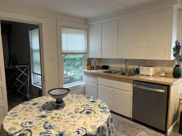 40 Silvermount St, Waterville, ME 04901 - kitchen featuring stainless steel dishwasher, ornamental molding, light countertops, and white cabinets