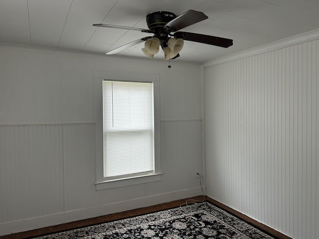 40 Silvermount St, Waterville, ME 04901 - unfurnished room with ceiling fan, dark wood-style flooring, crown molding, and a wainscoted wall