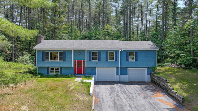 68 Hannibal Cir, Denmark, ME 04022 - bi-level home featuring driveway, a chimney, a garage, a shingled roof, and a front yard