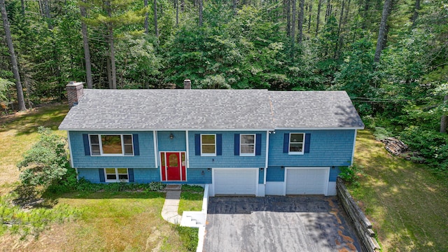 68 Hannibal Cir, Denmark, ME 04022 - raised ranch with driveway, a chimney, roof with shingles, and an attached garage