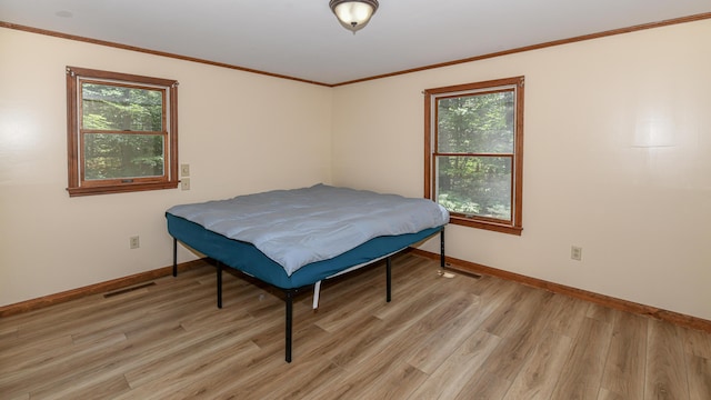 68 Hannibal Cir, Denmark, ME 04022 - bedroom featuring light wood finished floors, multiple windows, and ornamental molding