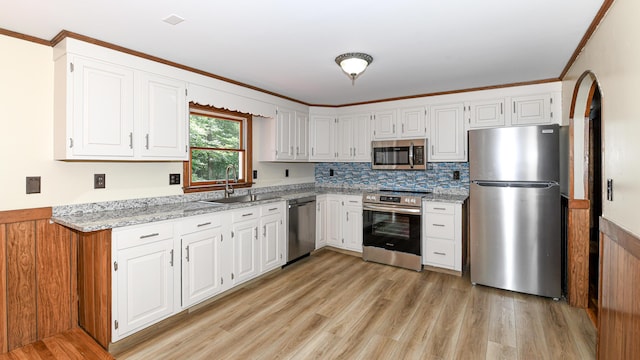 68 Hannibal Cir, Denmark, ME 04022 - kitchen with appliances with stainless steel finishes, light wood finished floors, white cabinets, and crown molding