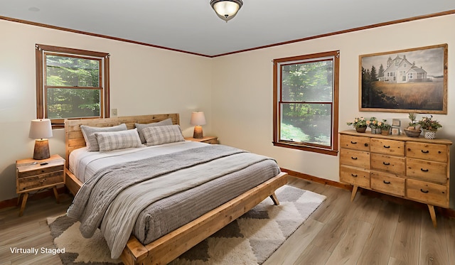 68 Hannibal Cir, Denmark, ME 04022 - bedroom with multiple windows, light wood-style flooring, and crown molding