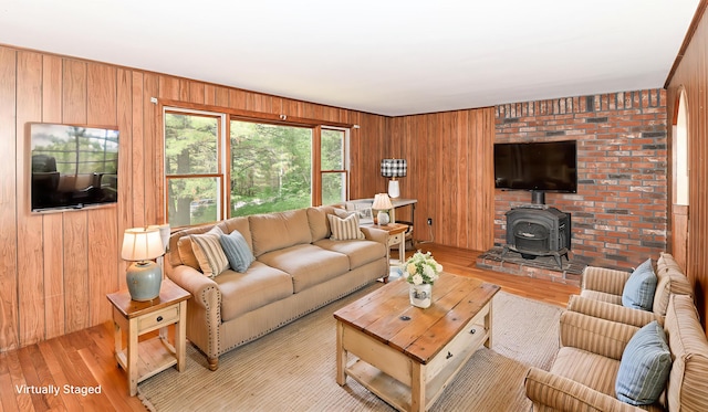 68 Hannibal Cir, Denmark, ME 04022 - living area featuring wooden walls, light wood-style flooring, and a wood stove