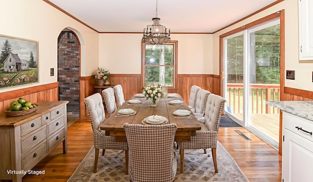 68 Hannibal Cir, Denmark, ME 04022 - dining room with a wainscoted wall, plenty of natural light, light wood finished floors, wooden walls, and crown molding