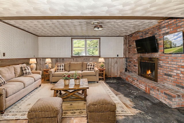 68 Hannibal Cir, Denmark, ME 04022 - living room with wallpapered walls, a fireplace, wood finished floors, ornamental molding, and wainscoting