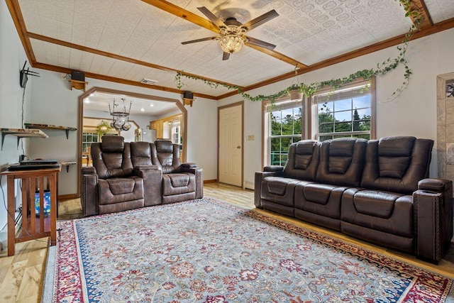 1080 Old Augusta Rd, Waldoboro, ME 04572 - living room featuring crown molding, light wood finished floors, a chandelier, and a ceiling fan