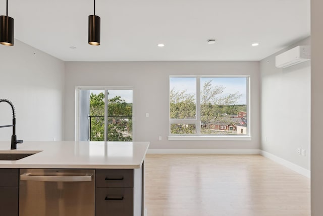 20 Upper Falls Rd Unit 403, Biddeford, ME 04005 - kitchen featuring stainless steel dishwasher, a wall unit AC, light countertops, light wood-style floors, and recessed lighting