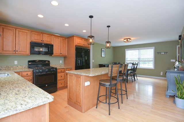 3 Erins Way S, Berwick, ME 03908 - kitchen featuring black appliances, light wood-style flooring, a center island, recessed lighting, and a breakfast bar