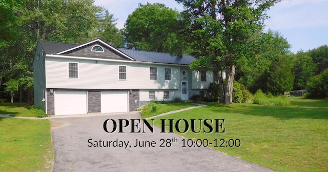53 Rte 106, Leeds, ME 04263 - split foyer home featuring asphalt driveway, a garage, a front lawn, and a metal roof