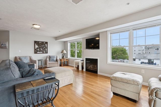 170 E Grand Ave Unit 8, Old Orchard Beach, ME 04064 - living area with light wood-style floors and a glass covered fireplace