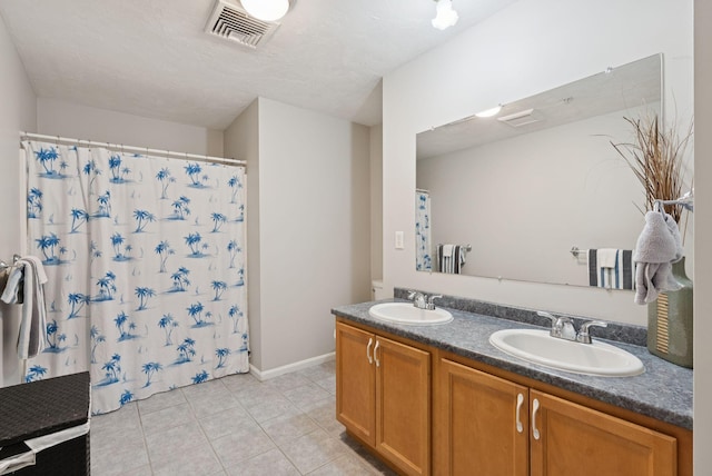 170 E Grand Ave Unit 8, Old Orchard Beach, ME 04064 - full bathroom with double vanity, tile patterned floors, and a shower with shower curtain