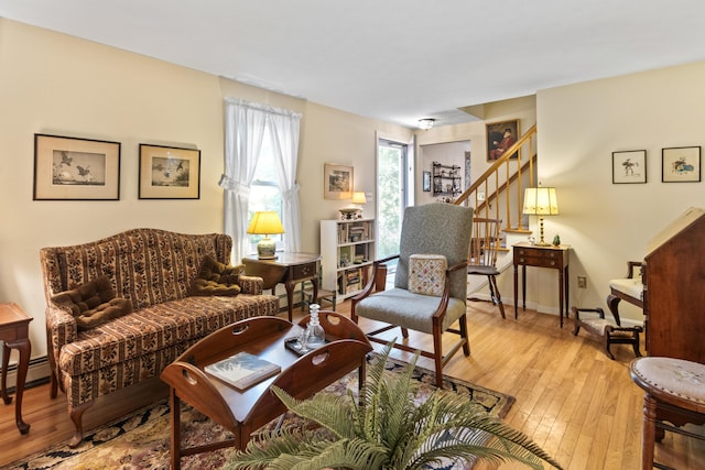 23 Laurel Pines Dr, Gorham, ME 04038 - living room featuring light wood-style floors, baseboard heating, and stairway
