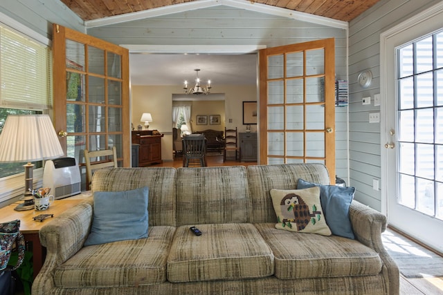 23 Laurel Pines Dr, Gorham, ME 04038 - living area featuring a chandelier, vaulted ceiling, and wood walls
