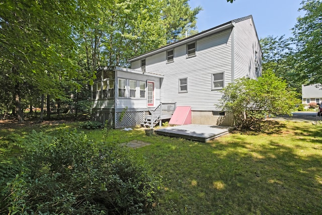 23 Laurel Pines Dr, Gorham, ME 04038 - rear view of property featuring a sunroom, a lawn, and a wooden deck