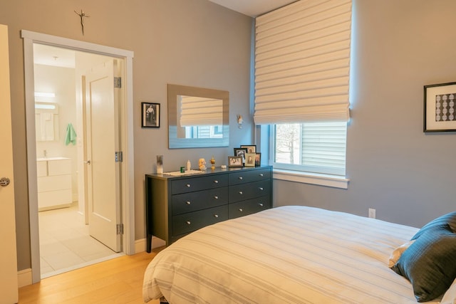 167 Newbury St Unit 206, Portland, ME 04101 - bedroom featuring light wood-type flooring and ensuite bathroom