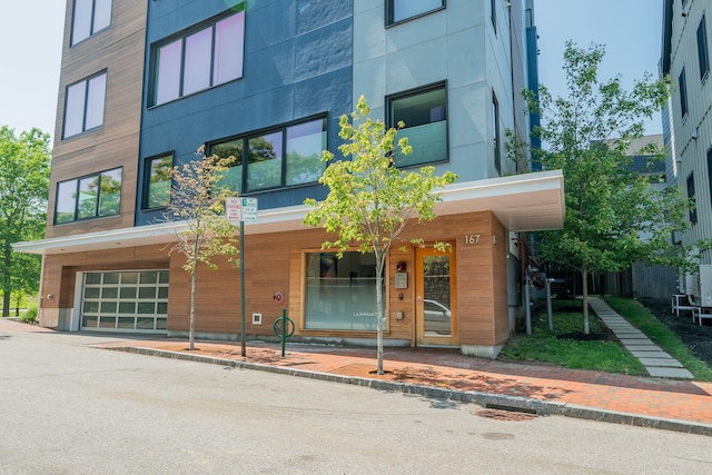 167 Newbury St Unit 206, Portland, ME 04101 - view of building exterior with an attached garage and driveway