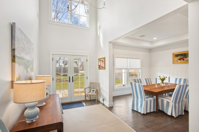 126 Mile Stretch Rd, Biddeford, ME 04005 - dining room featuring french doors, dark wood-style floors, a high ceiling, and a tray ceiling