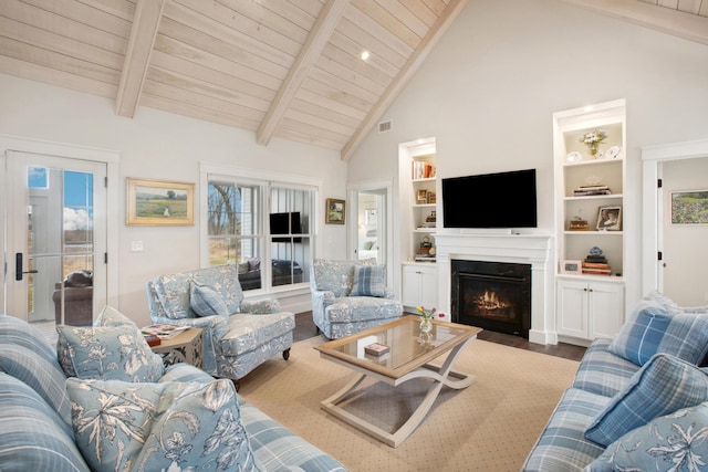 126 Mile Stretch Rd, Biddeford, ME 04005 - living area with a warm lit fireplace, wood finished floors, a wood ceiling with exposed beams, built in features, and high vaulted ceiling