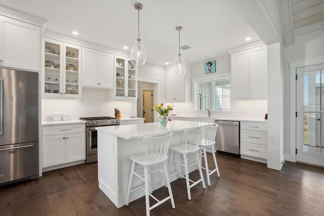 126 Mile Stretch Rd, Biddeford, ME 04005 - kitchen with stainless steel appliances, light countertops, decorative backsplash, white cabinets, and recessed lighting